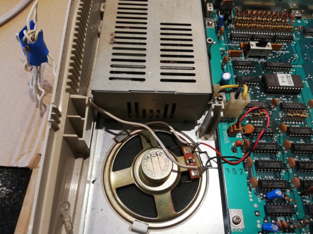 The mystery wires poking out of the case are connected (without solder) to the internal loudspeaker.