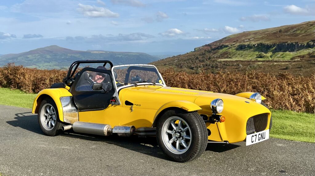 A yellow Caterham 7 pictured in the Brecon Beacons.